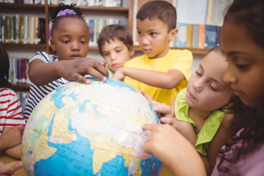 Children exploring a globe